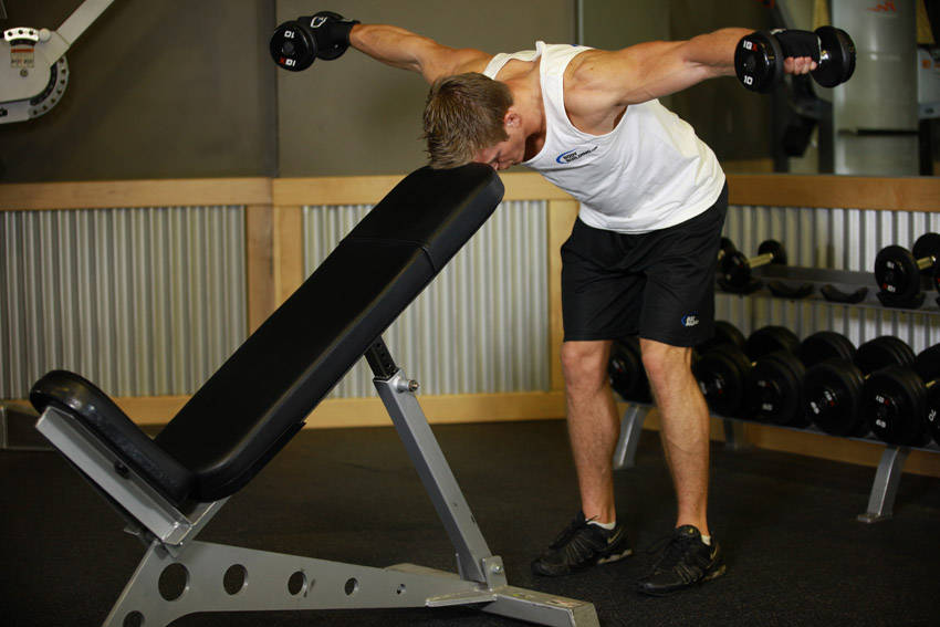 Bent Over Dumbbell Rear Delt Raise With Head On Bench — End position