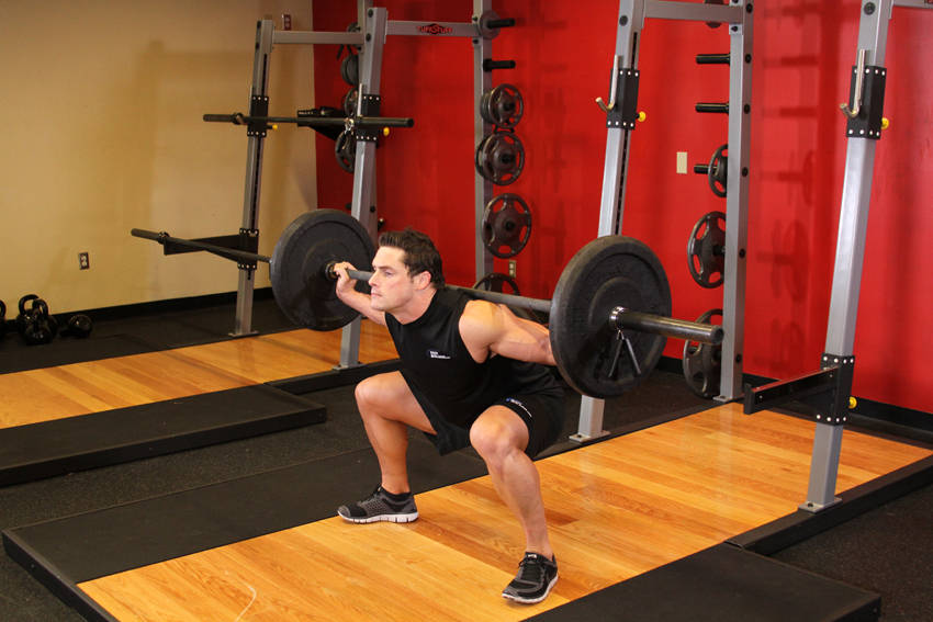 Wide Stance Barbell Squat — End position